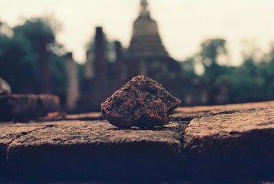 Close-up of bread on rock against sky