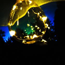 High angle view of lit candle in the dark