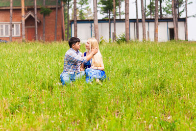 Full length of couple on field