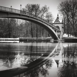 Bridge over lake at treptower park during winter