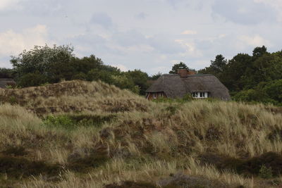 House on field against sky