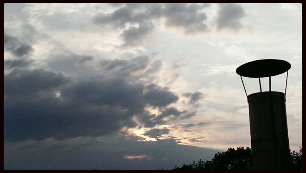 sky, low angle view, cloud - sky, cloudy, transfer print, silhouette, cloud, street light, auto post production filter, weather, overcast, nature, tranquility, dusk, scenics, beauty in nature, outdoors, tree, built structure, tranquil scene