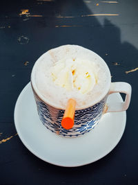 Coffee cup and ice cream on table