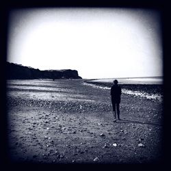 Silhouette of woman standing by tree