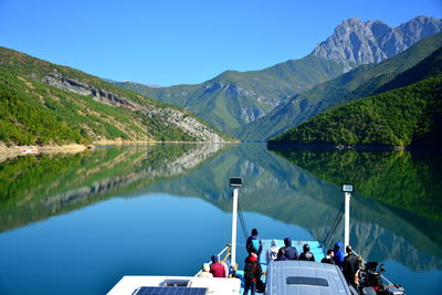 Lake koman is a reservoir on the drin river in northern albania, surrounded by dense forested hills,