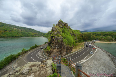 Panoramic view of road by mountain against sky