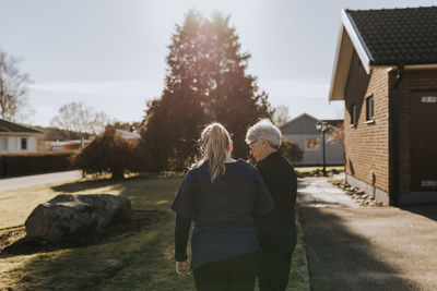 Home caretaker going on walk with senior woman