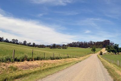 Dirt road along countryside landscape