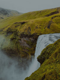 Scenic view of waterfall against sky