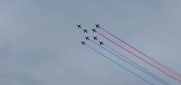 Low angle view of airshow against sky