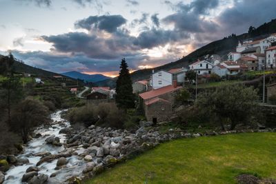 View of townscape by mountain against sky