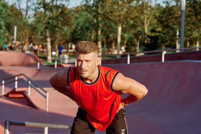 Portrait of young man exercising in gym