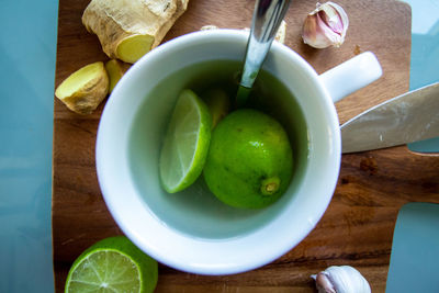 High angle view of green fruits in container on table