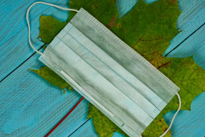 High angle view of paper against blue background