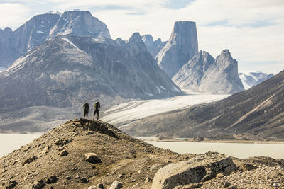 Panoramic view of people walking on mountain against sky