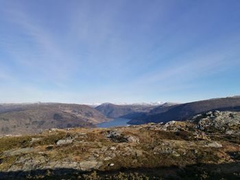 Scenic view of mountains against blue sky