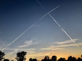 Low angle view of vapor trails in sky