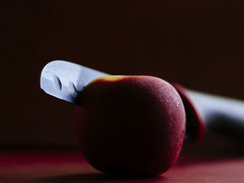 Close-up of apple on table against black background