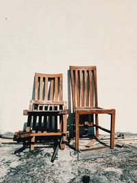 Empty chairs and tables against wall