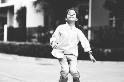 Portrait of smiling girl standing outdoors