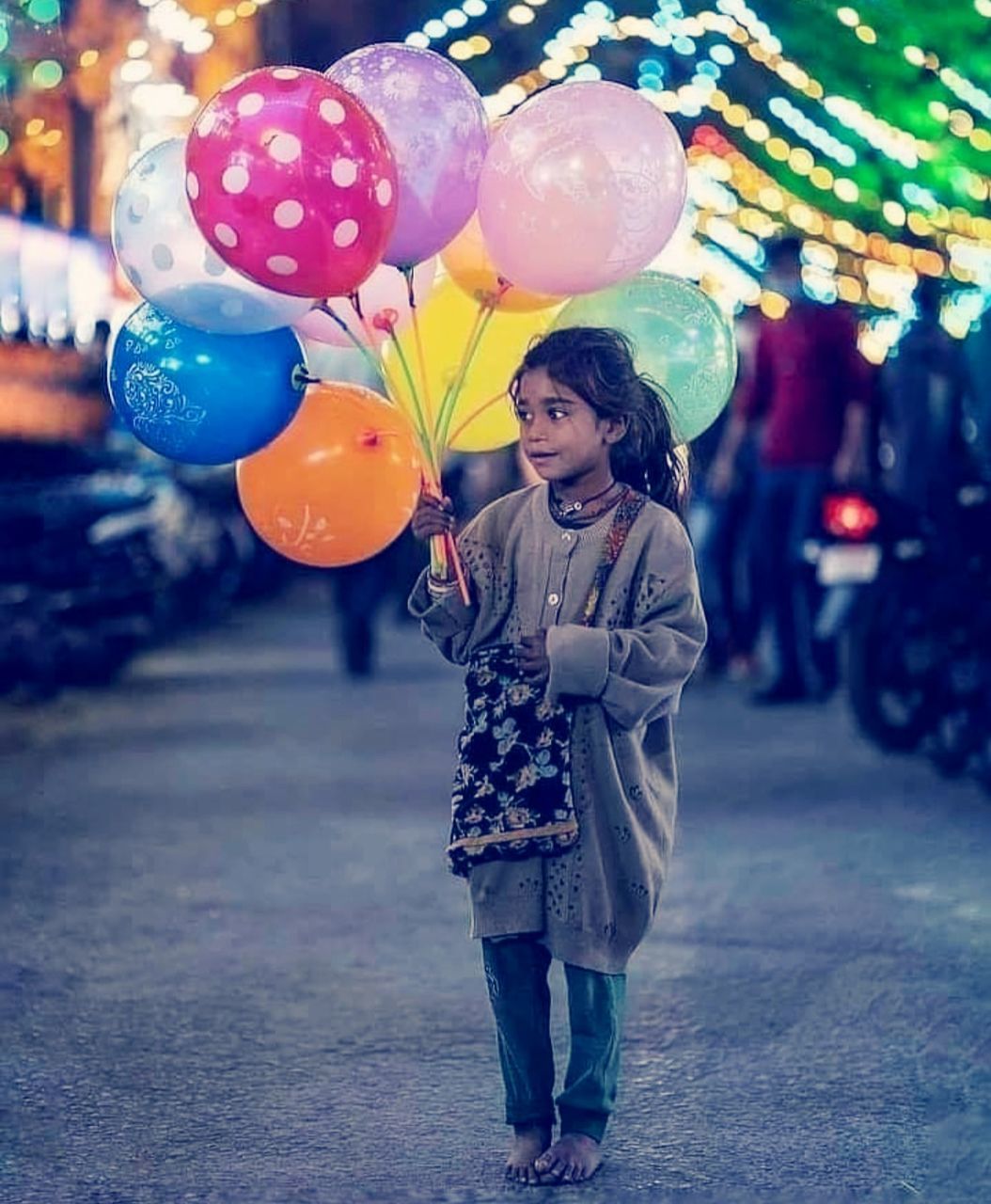 balloon, celebration, one person, happiness, emotion, adult, event, smiling, city, multi colored, women, positive emotion, fun, decoration, street, standing, helium balloon, child, cheerful, full length, joy, young adult, childhood, female, clothing, holding, nature, outdoors, lifestyles, party, enjoyment, architecture, holiday, night, carefree, person, cute, fashion, casual clothing, city life