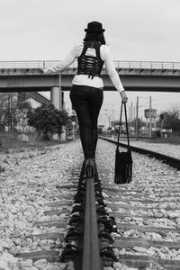 Woman standing on bridge