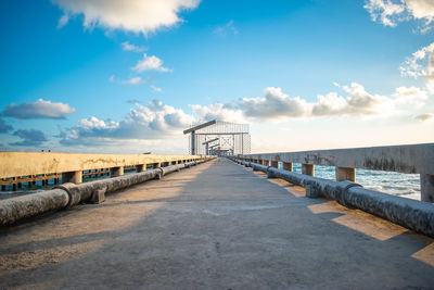 Bridge over sea against blue sky