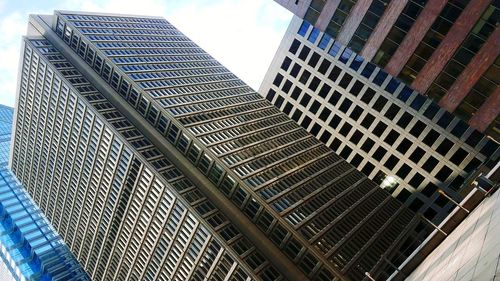 Low angle view of modern buildings against sky in city