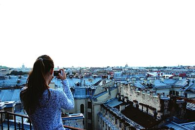 Rear view of woman standing in city