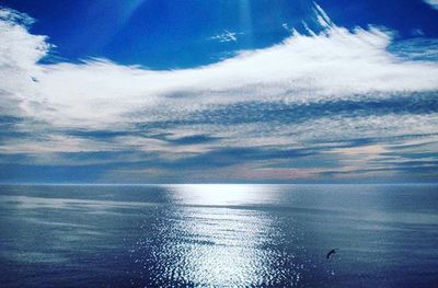 Scenic view of sea against cloudy sky