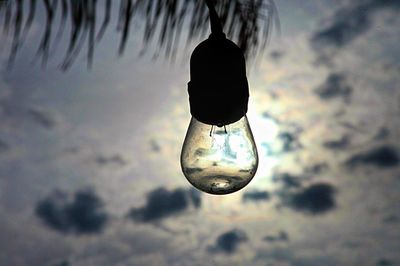 Low angle view of light bulb against sky