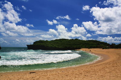 Scenic view of beach against blue sky