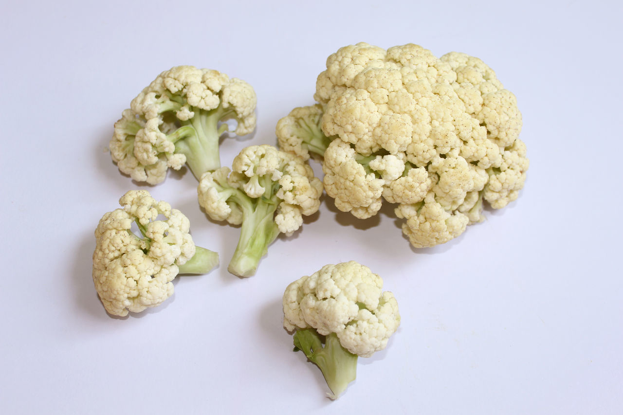 HIGH ANGLE VIEW OF VEGETABLES ON WHITE SURFACE
