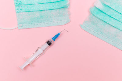 High angle view of medical equipment on pink background