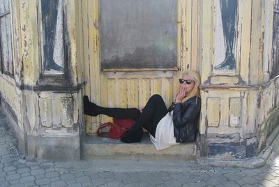 Portrait of smiling young woman sitting outdoors