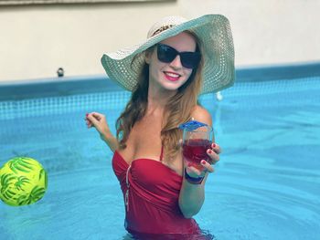 Young woman wearing hat in swimming pool