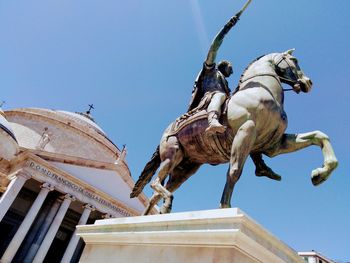 Low angle view of statue against clear blue sky