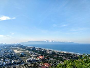 High angle view of townscape by sea against sky