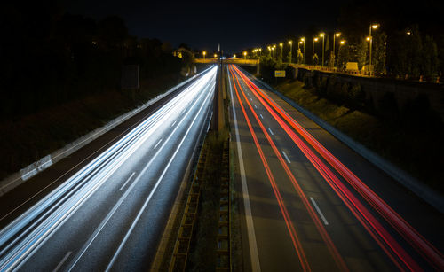 High angle view of light trails on highway at night