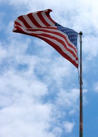 Low angle view of flag against sky