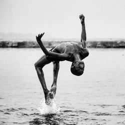 Man backflipping in ganges river