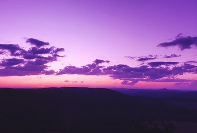 Scenic view of dramatic sky over silhouette landscape