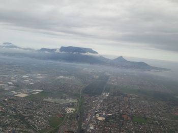Aerial view of landscape against cloudy sky