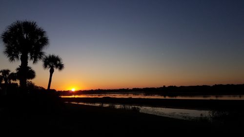 Scenic view of sea against clear sky during sunset