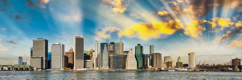 Panoramic view of sea and buildings against sky