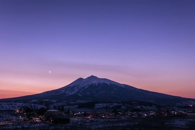 Scenic view of mountains against sky at sunset