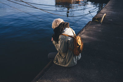 Rear view of woman sitting in boat