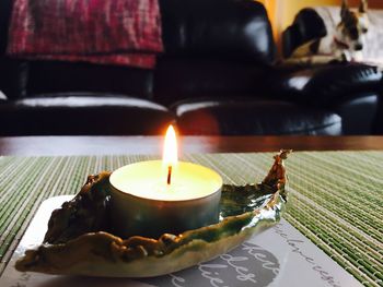 Close-up of illuminated lamp on table