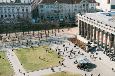 High angle view of people on street by buildings in city