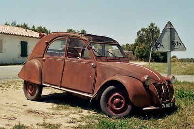 Vintage car on field against clear sky